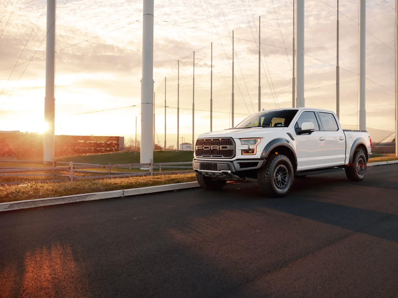 White Ford F-150 pickup, front three-quarter view at sunset